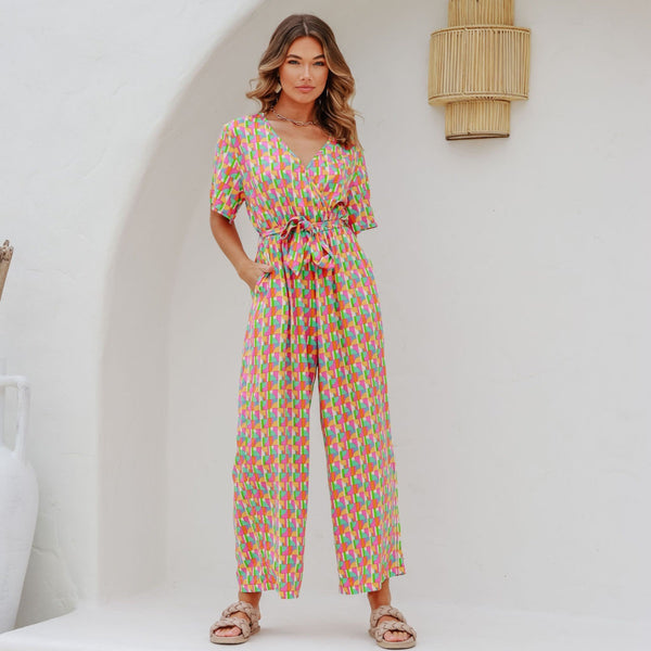 Astra Jumpsuit has a fun geo print in pink, green, yellow and white