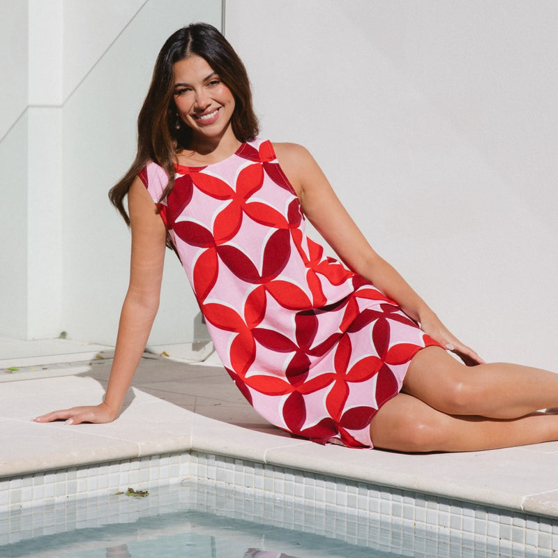 The dress has a round neckline and its a sleeveless design.