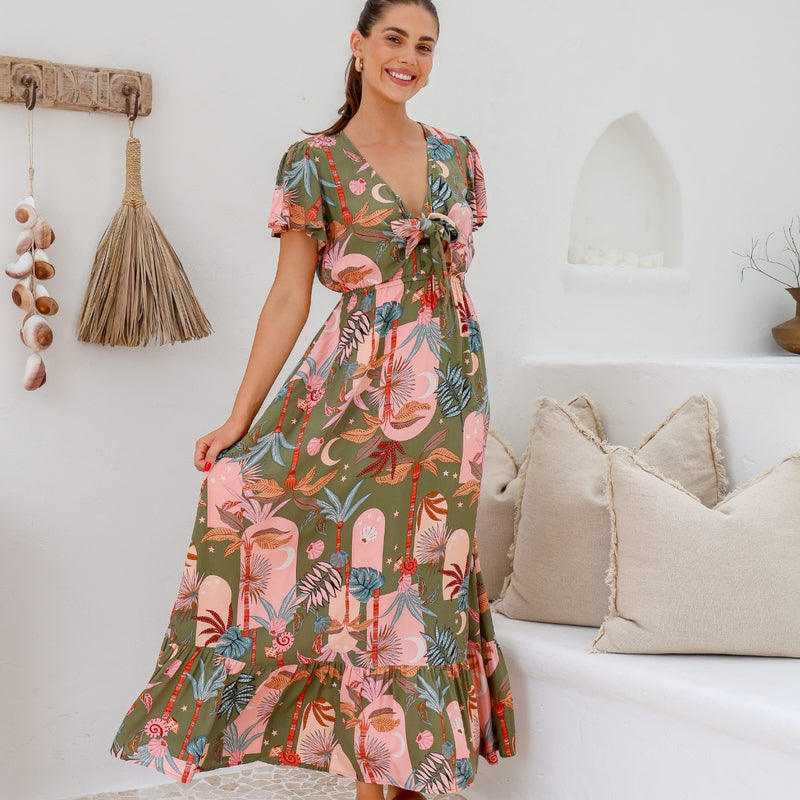 This maxi dress has a V neckline, ties on the bodice and a long flowing skirt with a frill hemline
