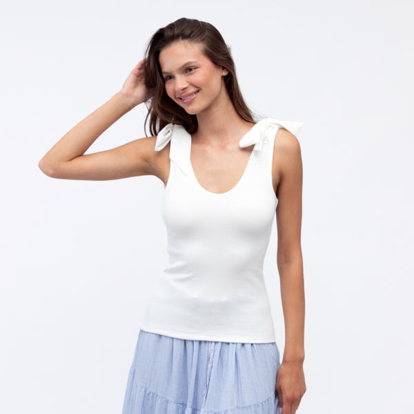 Emma Bow Top in white. This singlet top has a deep scoop neckline at the front and it has bows on the shoulder.