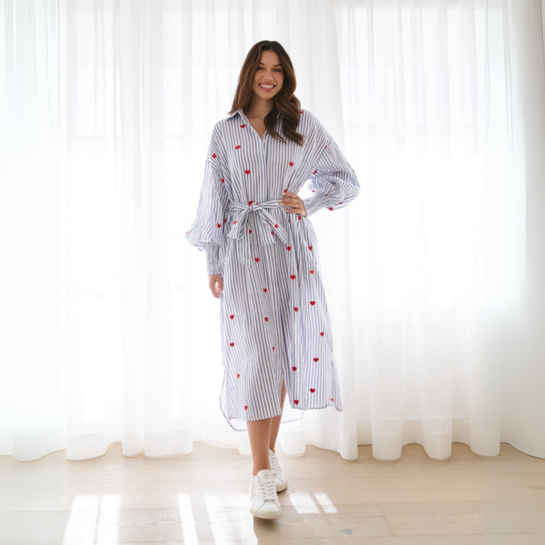 Our Felicity Dress has blue and white stripes with red embroidered hearts throughout.