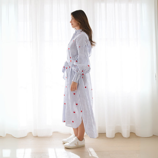 Side view of this shirt dress - it has a curved hem, longer at the back.