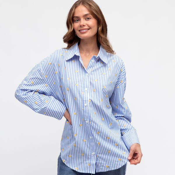 The shirt has a collar, button front, long sleeves with button cuffs.