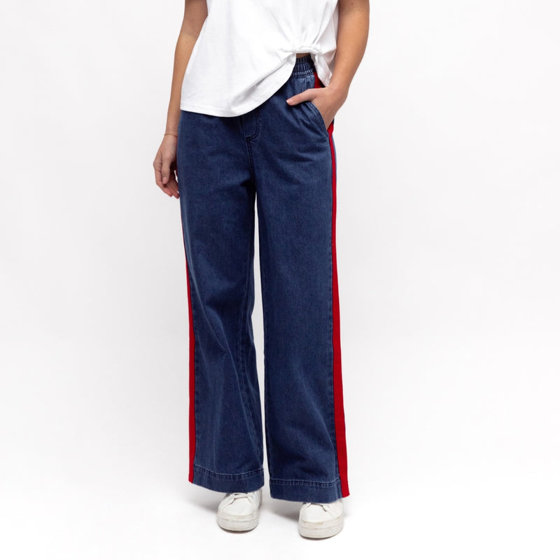Our Luna Denim Pants are in a mid blue wash and they feature a red side stripe. They also feature an elasticated waist with drawstring ties, front pockets and a relaxed straight leg.