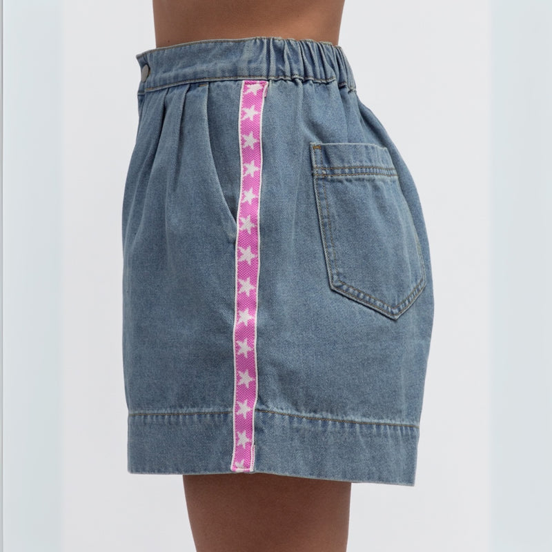 Side view of the shorts with a pink and white star stripe.