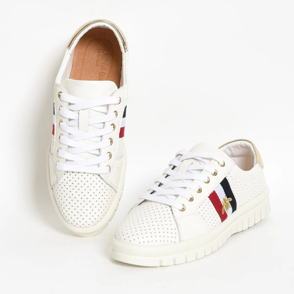 These white sneakers have cotton laces across gold eyelets.