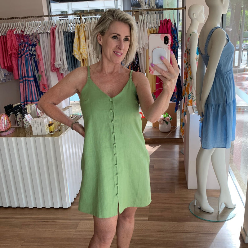 This Summery linen dress has thin adjustable straps, button front, pockets and it sits above the knee