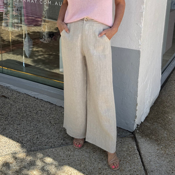 Our Jude Linen Pants in natural. They have a straight leg, slightly wider at the base.