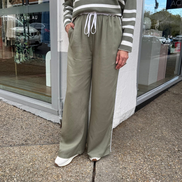 Our Lottie Tencel Pants in khaki have a relaxed straight leg and a white elasticated waist with drawstring ties.