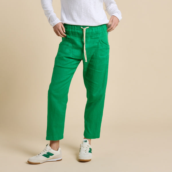 These pants have an elasticated waist with calico drawstring ties, front pockets and they have a tapered leg.