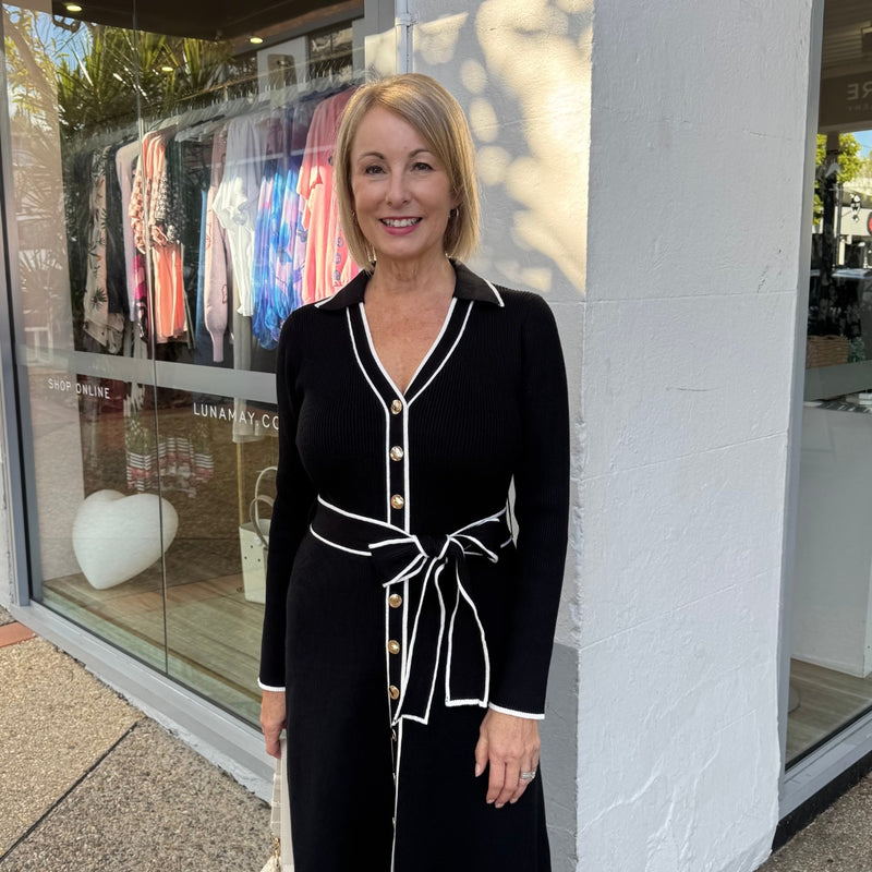 Close up of the bodice area - featuring the collar, V neckline, gold button front, waist tie and the white ribbed accents (edge of collar, V neckline, vertically down the front, on the sleeve edge and waist tie).