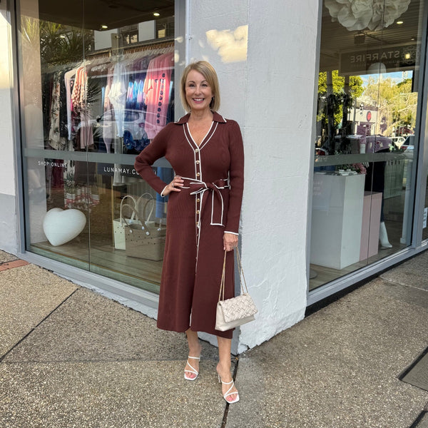 Our Astrid Knit Midi Dress is available in a lovely chocolate brown colour with white ribbed accent stripes.
