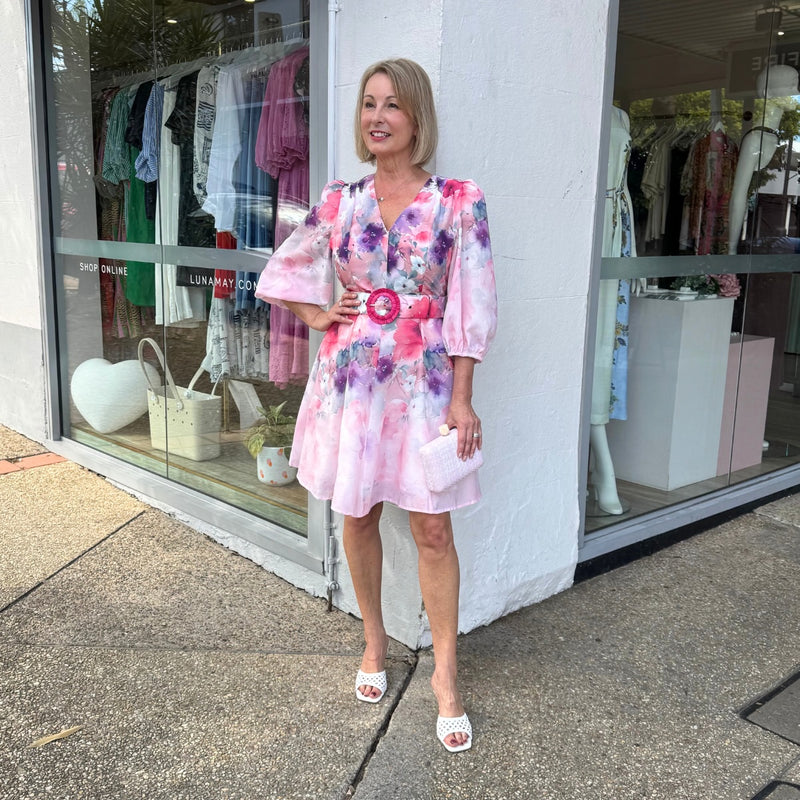 The dress has a V neckline, 1/2 length sleeves, detachable self print belt and a full skirt that sits above the knee.