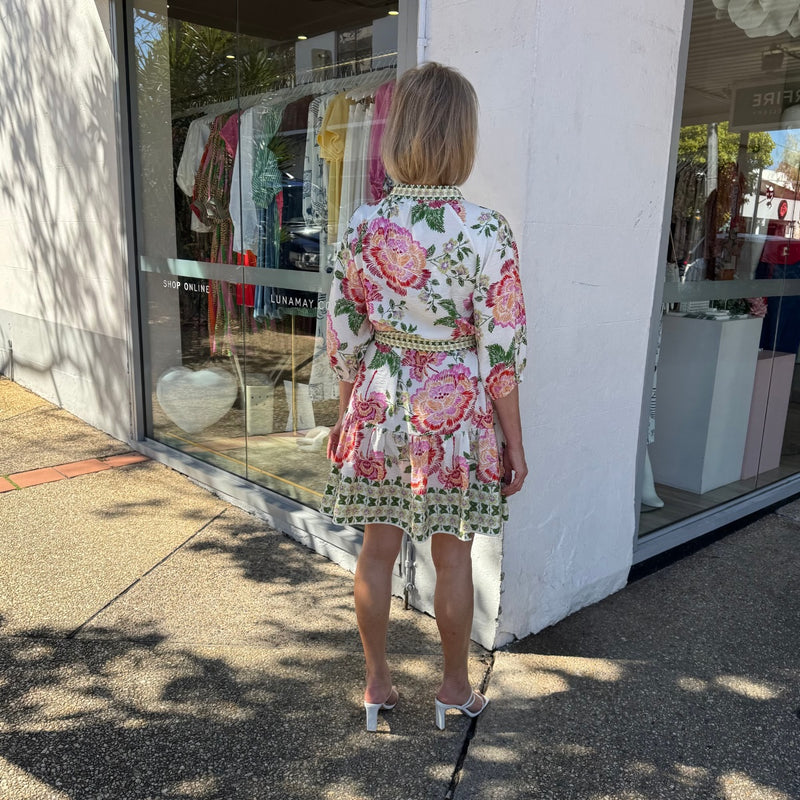 Full length view of the back of the dress. It has a frill hem.