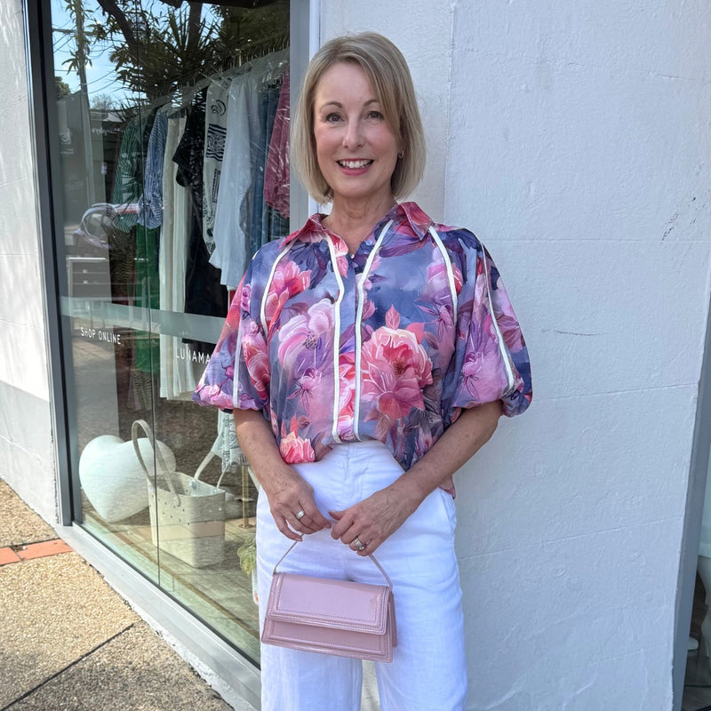 Our Constance Shirt has a lovely pink, navy and purple floral print.