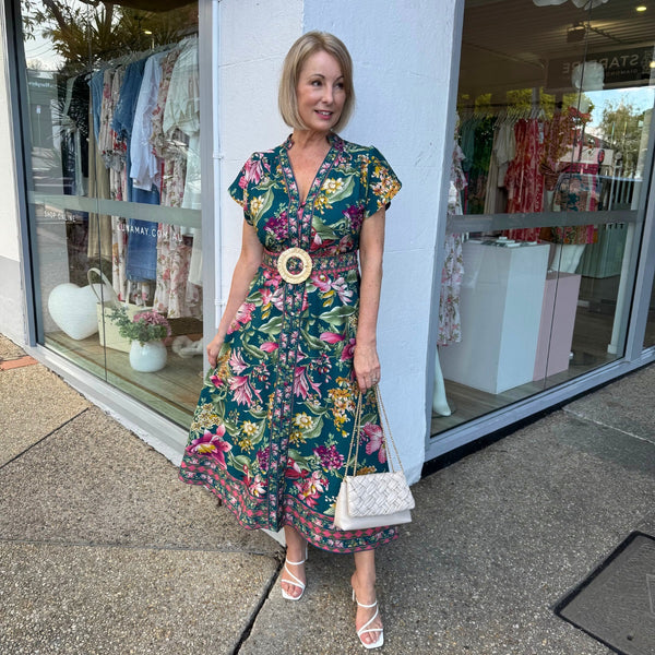 The dress can be accessorised with heels and a cream bag.