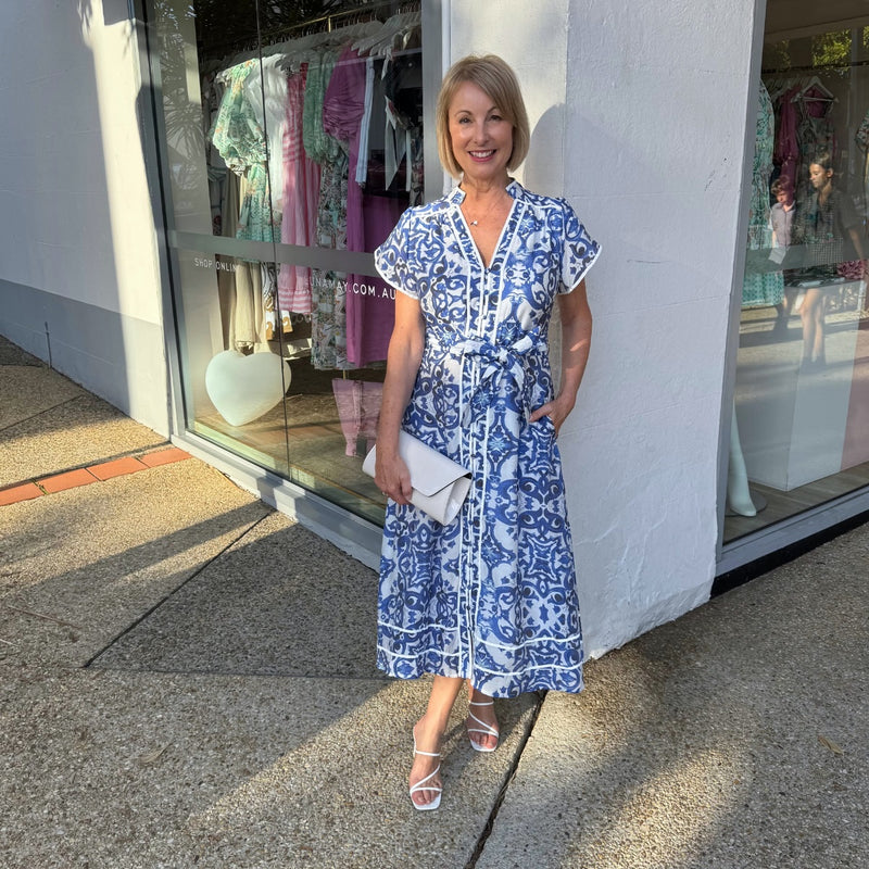 Accessorise with heels and a white clutch.