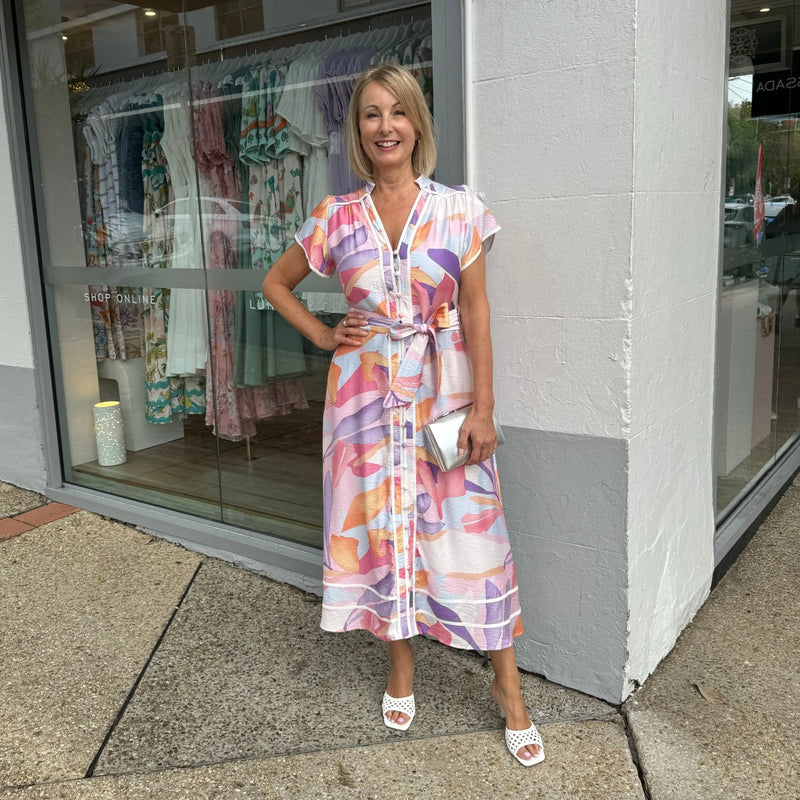 Our Kacey Midi Dress in an abstract watercolour inspired print with pink, purple, white, blue and orange tones.