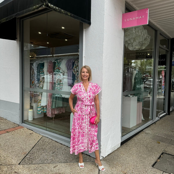 The dress looks fab with a hot pink clutch