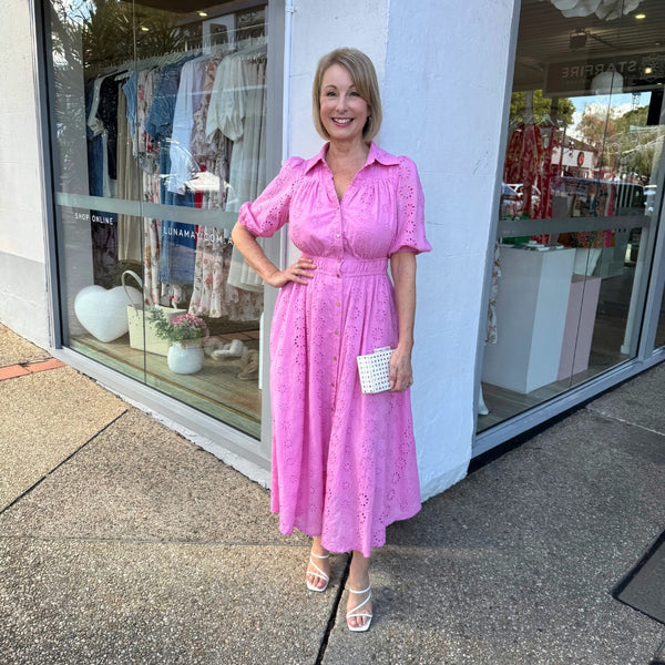 This pink lace dress features a collar, button down front, short sleeves, elasticated waist and a full midi length skirt.
