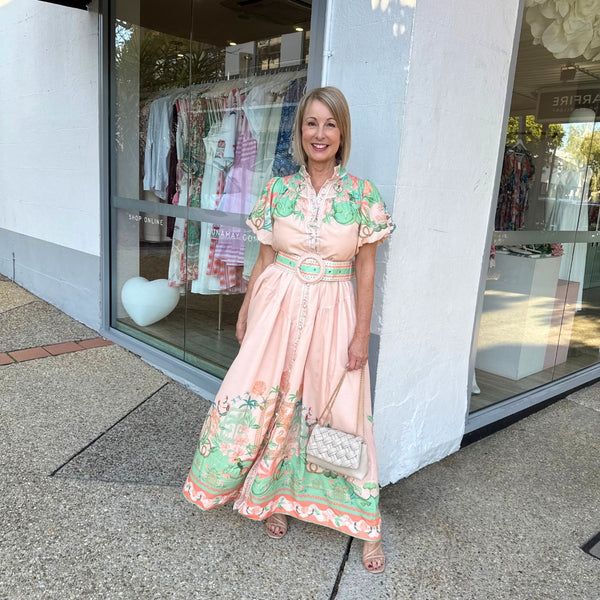 The dress has a fitted bodice, maxi skirt and short puff sleeves.