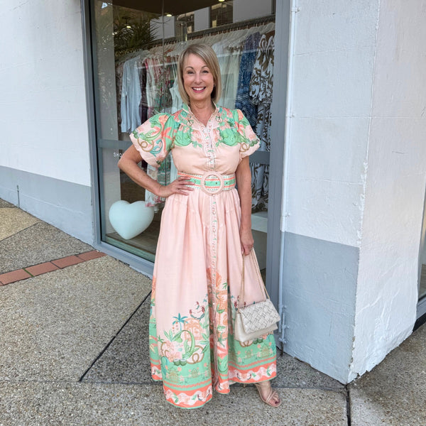 Our Aurora Cove Maxi Dress is in a gorgeous peach and green print.