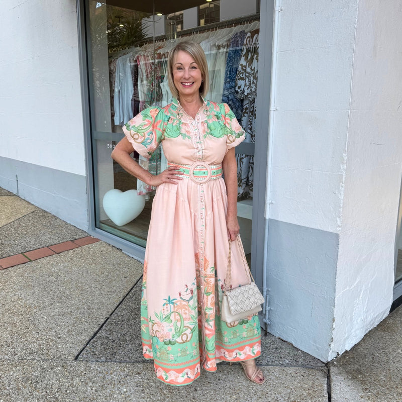 Our Aurora Cove Maxi Dress is in a gorgeous peach and green print.