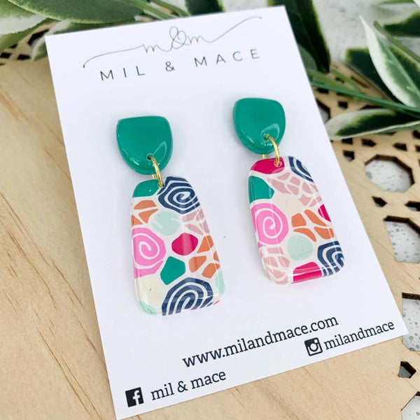 Lolly Floral Clay Earrings with a pink, green, navy and mustard floral design and a green stud 