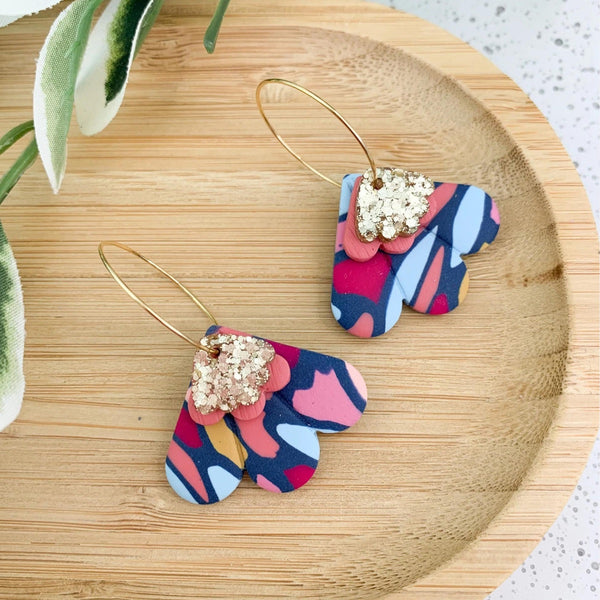 Petal Clay Dangle Hoop Earrings in a blue multi abstract design with a gold hoop