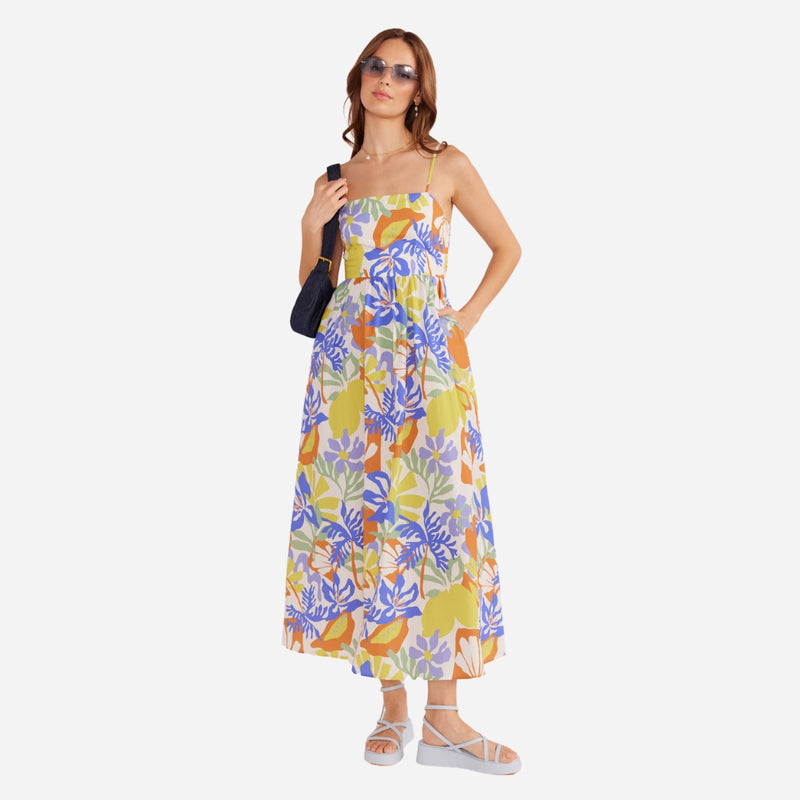 Our Dahlia Midi Dress has a fun tropical print in white, yellow, green, blue and a burnt orange colour.