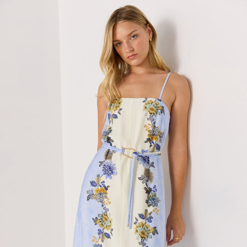 Close up of the bodice area featuring a square neckline, thin shoulder straps and a detachable self print belt.