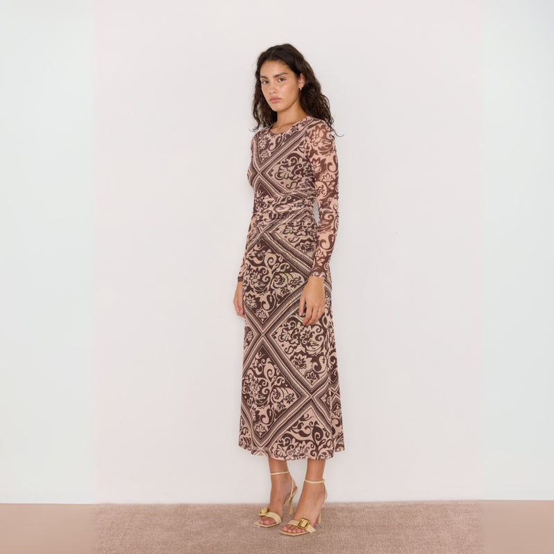 Side view of the dress - features a round neckline, long sleeves and an Aline midi skirt.