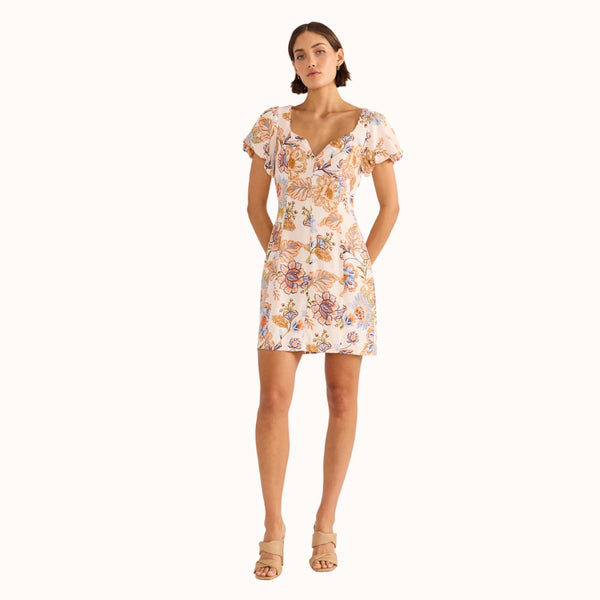 Our Marceline Floral Mini Dress has an exclusive print in white, blue, peach, green and brown tones.