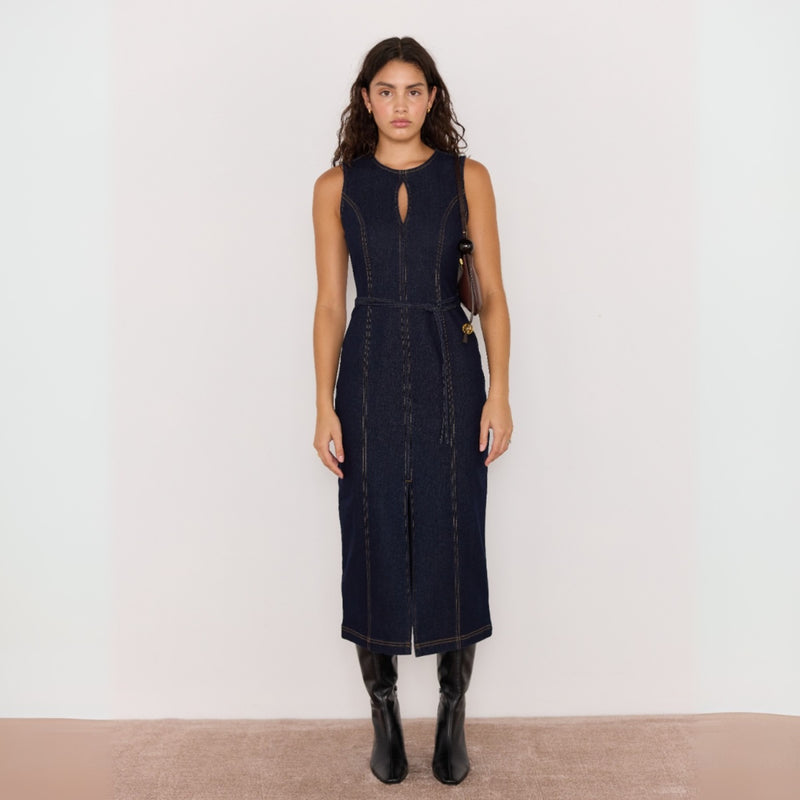 Our Raya Denim Dress is midi length and available in a dark indigo wash. Shown here worn with boots.