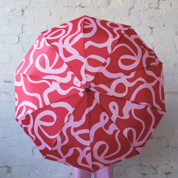 Mosey Me Ribbon Umbrella with an original pink and red ribbon design.
