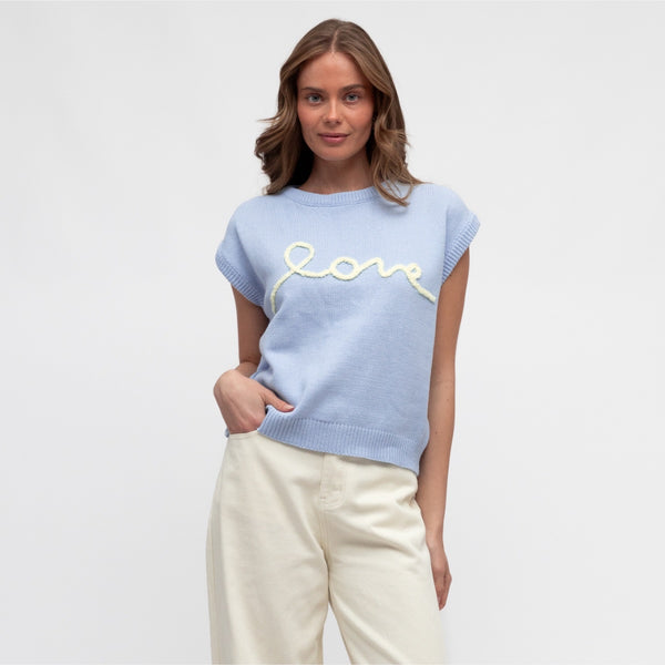 Our Love Knit Vest is available in a pale blue colour with the word 'LOVE' stitched on the front in a pale yellow colour.