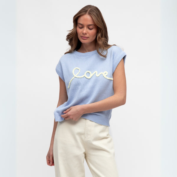 The knitted top has a round neckline, extended sleeves and a ribbed hem.