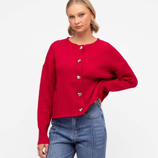 The cardigan has a round neckline, drop shoulder, long sleeves and functional gold buttons on the front.