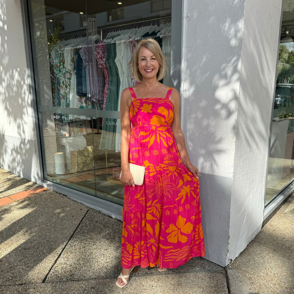 Our Elio Maxi Dress is available in a pink and orange tropical inspired print.