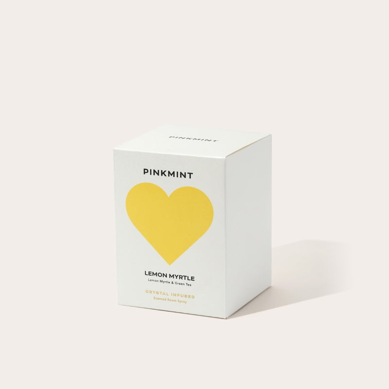 The room spray is packaged in a white box with a yellow heart on the front.