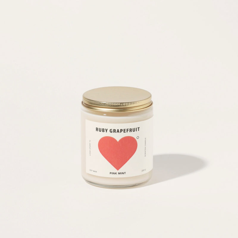 This candle has a gold screw top lid.
