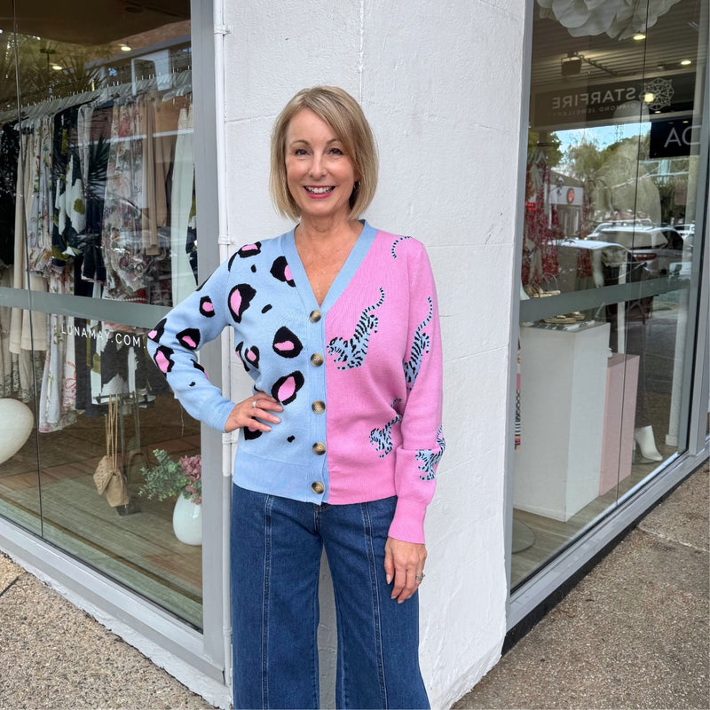 Our Ira Cardigan is available in pink, blue and black. It has a V neckline, long sleeves, button front and a ribbed hem.