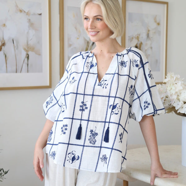 This top has a round neckline with V cut-out, half length sleeves, navy tassel ties and a loose fit body.