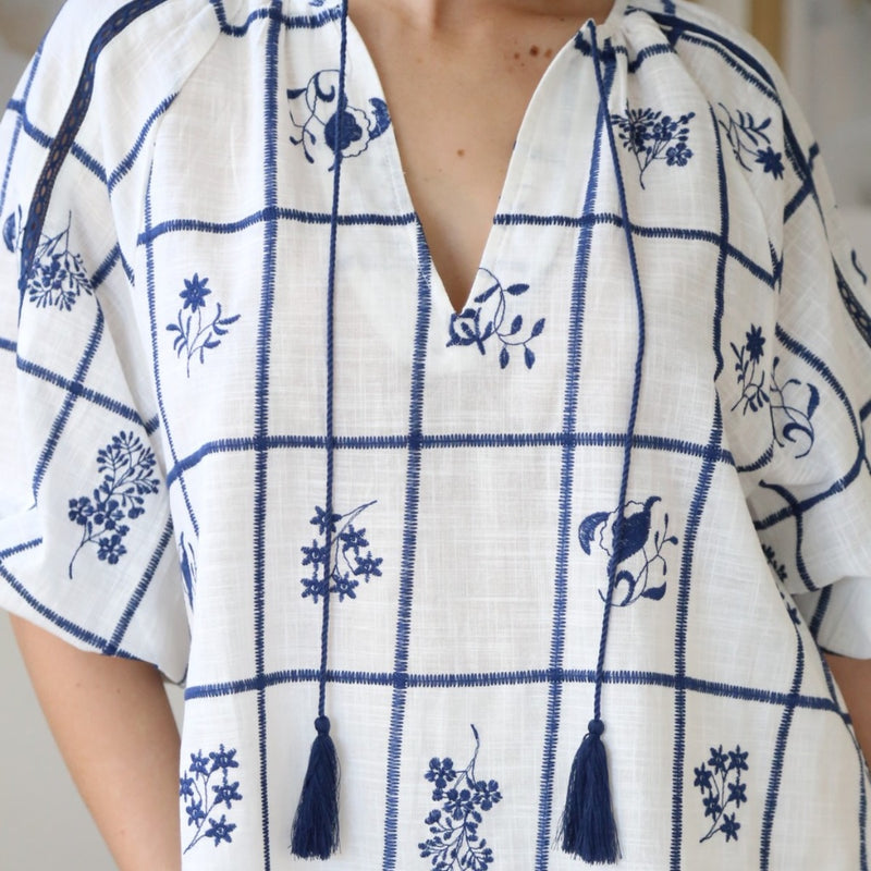Close up of the neckline with the navy tassels.