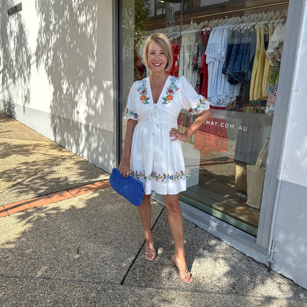 Accessorise with heels and a bright blue clutch.