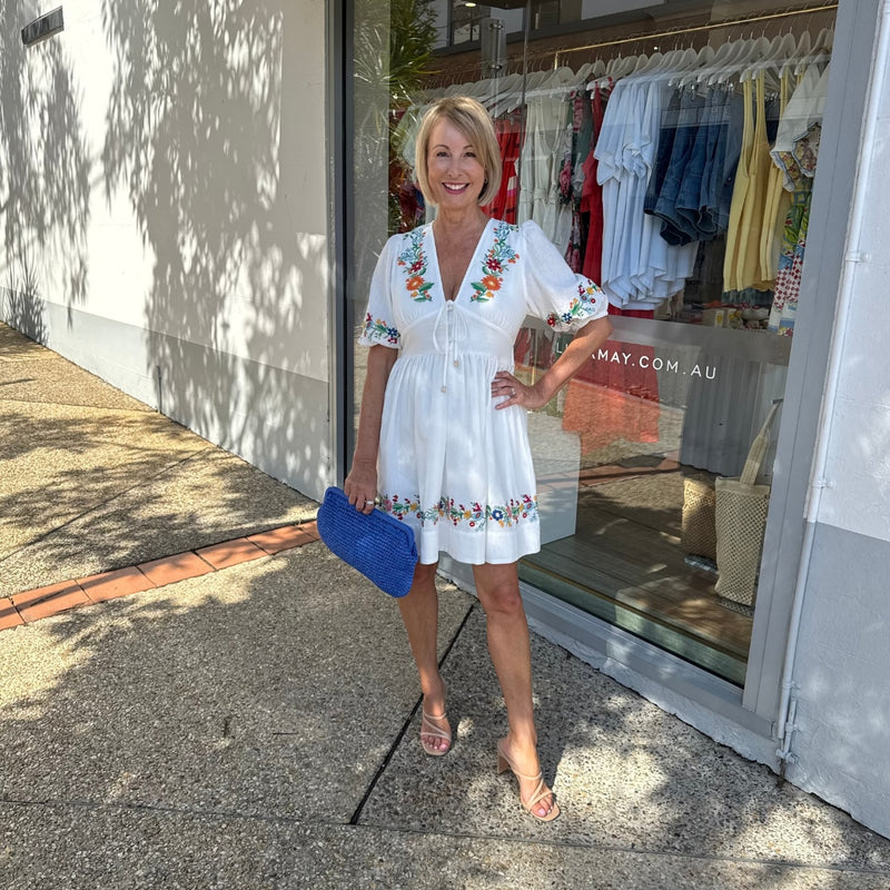 Accessorise with heels and a bright blue clutch.
