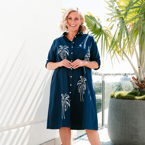 This shirt dress has a collar, button front, long sleeves that can be rolled up and fastened and it has an Aline body.