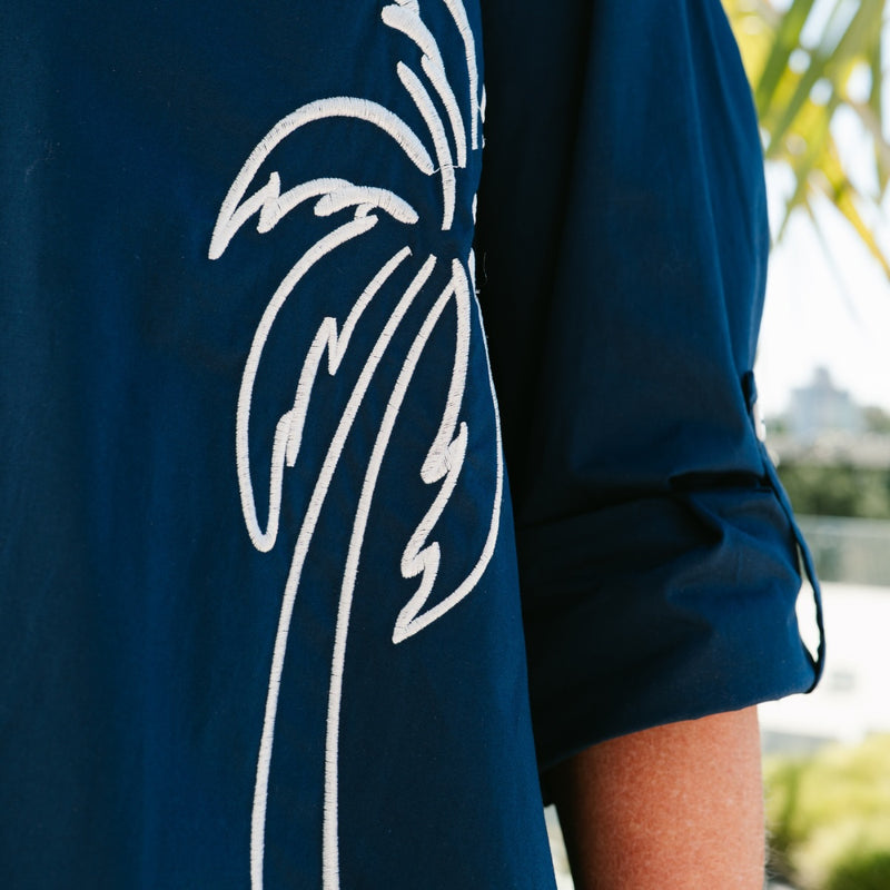 Close up of the white embroidered palm tree.
