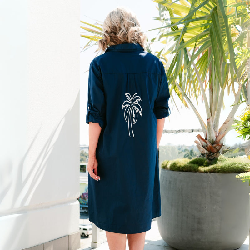 Back view of the dress and it has a large white embroidered palm tree on the centre of the back.