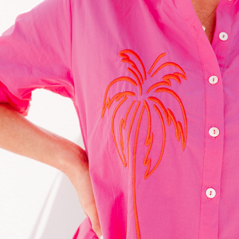 Close up of the embroidered palm tree in orange.